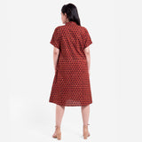 Back View of a Model wearing Red Floral Block Printed Cotton Knee Length Shirt Dress