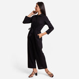 Left View of a Model wearing Black Wide Legged Cotton Overall