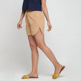 Left View of a Model wearing Beige 100% Cotton Low-Rise Short Shorts