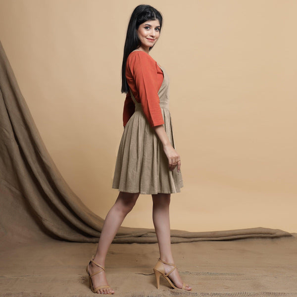 Right View of a Model wearing Beige Pleated Cotton Flax Knee Length Criss-Cross Back Dress