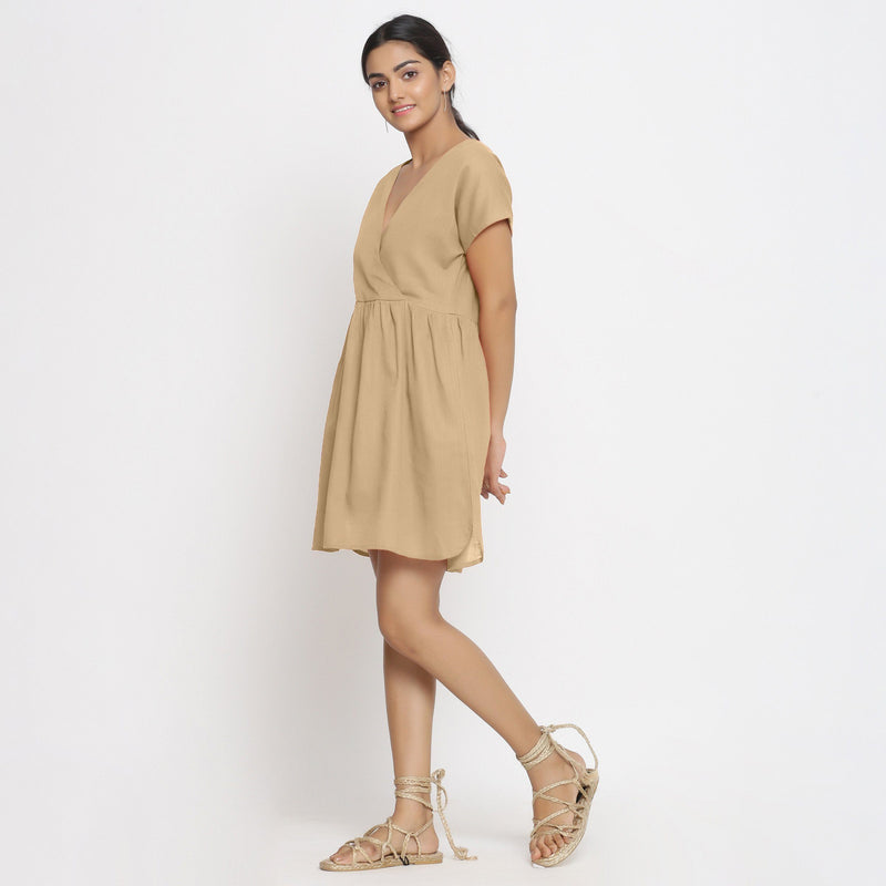 Left View of a Model wearing Beige Cotton Solid Wrap Dress