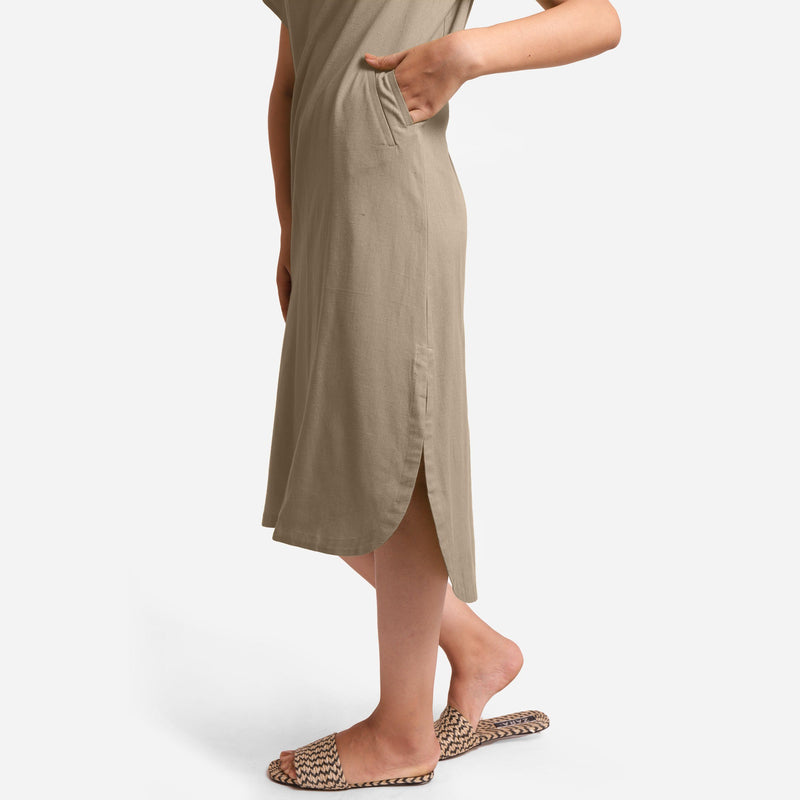 Left View of a Model wearing Beige Cotton Welt Pocket Shift Dress