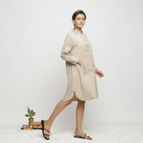 Right View of a Model wearing Beige Dabu Hand-Lep Cotton Knee Length Shirt Dress