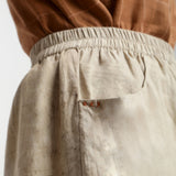 Right Detail of a Model wearing Beige Dabu Print Cotton Flared Shorts