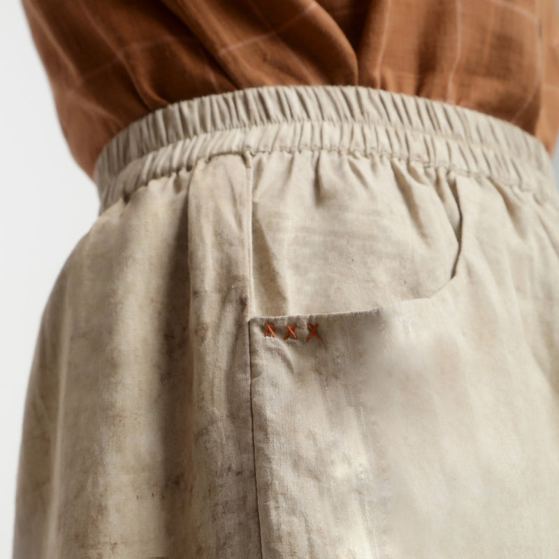 Right Detail of a Model wearing Beige Dabu Print Cotton Flared Shorts