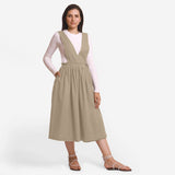 Front View of a Model wearing Beige Deep Neck Pinafore Midi Wrap Dress