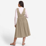 Back View of a Model wearing Beige Deep Neck Pinafore Midi Wrap Dress