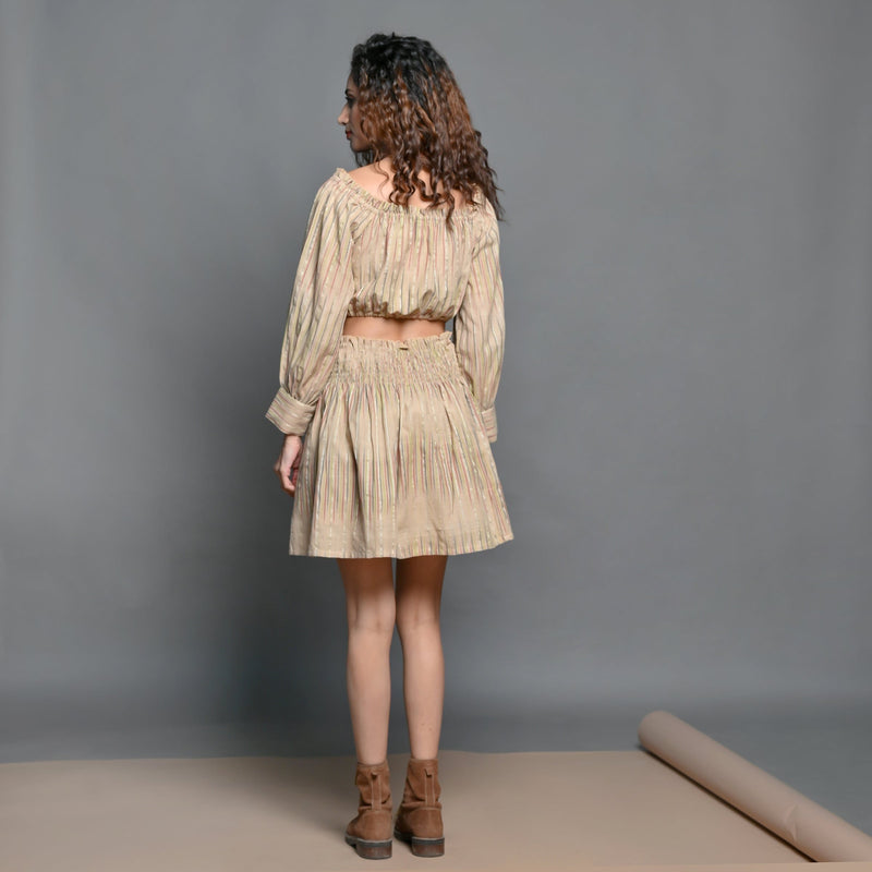 Back View of a Model wearing Beige Handwoven Cotton Frilled Blouson Crop Top