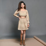 Front View of a Model wearing Beige Handwoven Cotton Frilled Blouson Crop Top