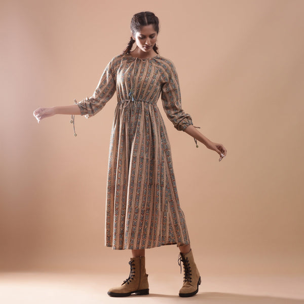 Left View of a Model wearing Beige Kalamkari Block Print Cotton Midi Dress