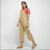 Left View of a Model wearing Beige Strap Sleeve Solid Dungaree