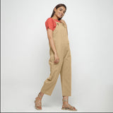 Right View of a Model wearing Beige Strap Sleeve Solid Dungaree