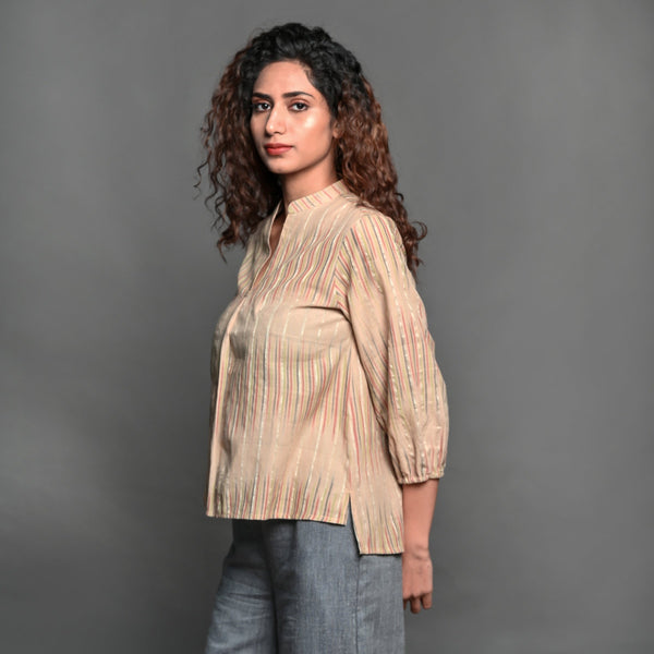 Left View of a Model wearing Beige Striped Handwoven Cotton Split Neck Pleated Shirt