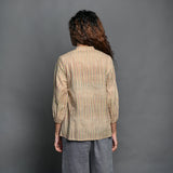 Back View of a Model wearing Beige Striped Handwoven Cotton Split Neck Pleated Shirt