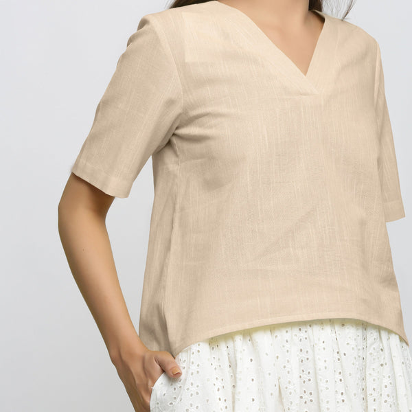 Front Detail of a Model wearing Beige Yarn Dyed 100% Cotton V-Neck High-Low Top