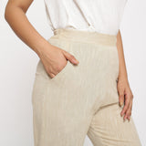 Right Detail of a Model wearing Beige Yarn Dyed Mid Rise Tapered Pant