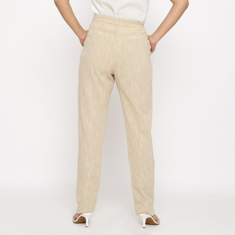 Back View of a Model wearing Beige Yarn Dyed Mid Rise Tapered Pant