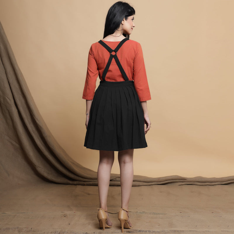 Back View of a Model wearing Black Pleated Cotton Flax Knee Length Criss-Cross Back Dress