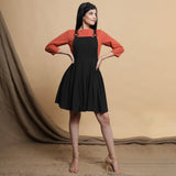 Front View of a Model wearing Black Pleated Cotton Flax Knee Length Criss-Cross Back Dress