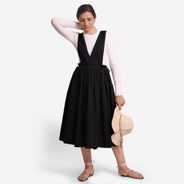 Front View of a Model wearing Black Deep Neck Pinafore Midi Wrap Dress