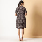Back View of a Model wearing Block Printed Black Floral Button-Down Dress