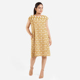 Front View of a Model wearing Mustard Block Printed Cotton Knee Length Yoke Dress