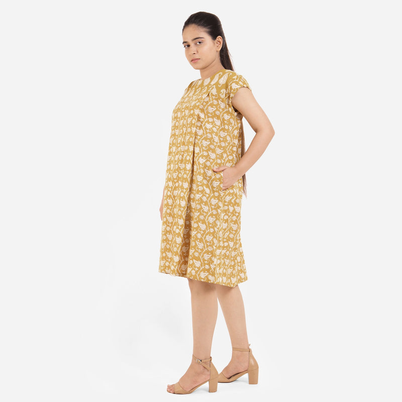 Left View of a Model wearing Mustard Block Printed Cotton Knee Length Yoke Dress