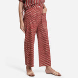 Right View of a Model wearing Brick Red Block Printed Cotton Ankle Length Pant