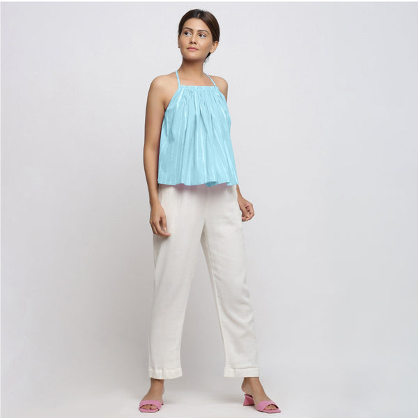 Front View of a Model wearing Blue Camisole Top and White Tapered Pant Set