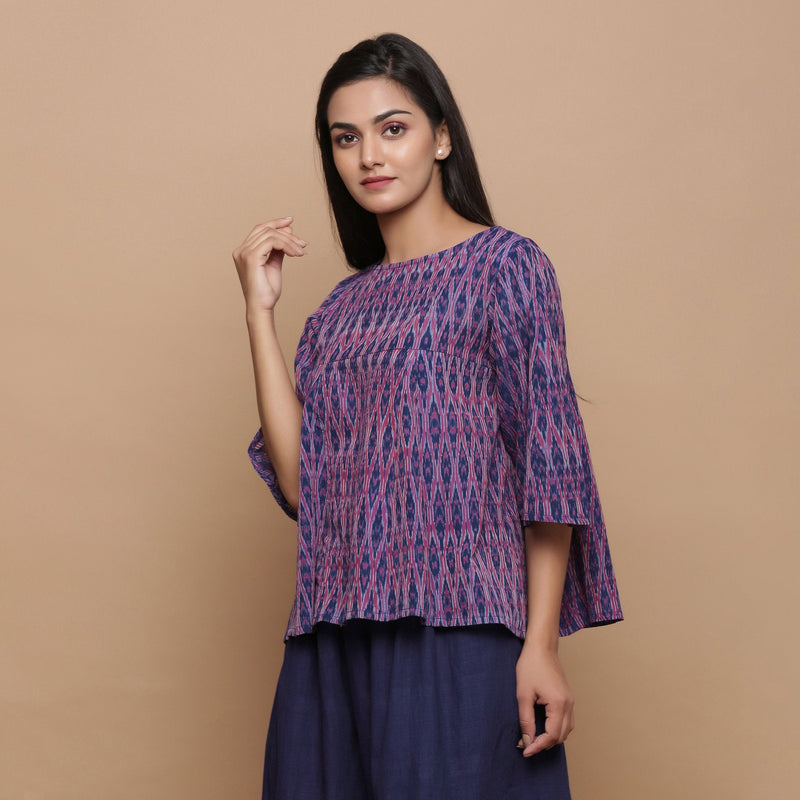 Left View of a Model wearing Blue Handwoven Cotton Ikat Godet Flared Top