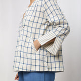 Left View of a Model wearing Off-White and Blue Vegetable Dyed Handspun Cotton Asymmetrical V-Neck Outerwear