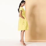 Right View of a Model wearing Lemon Yellow Frilled Cotton Knee Length Bohemian Dress