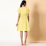 Back View of a Model wearing Lemon Yellow Frilled Cotton Knee Length Bohemian Dress