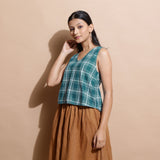 Left View of a Model wearing Bottle Green Cotton Sleeveless Top