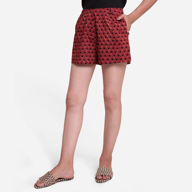 Front View of a Model wearing Brick Red Block Print Floral Hot Pants