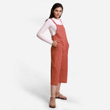 Right View of a Model wearing Brick Red 100% Cotton Pinafore Midi Dungaree