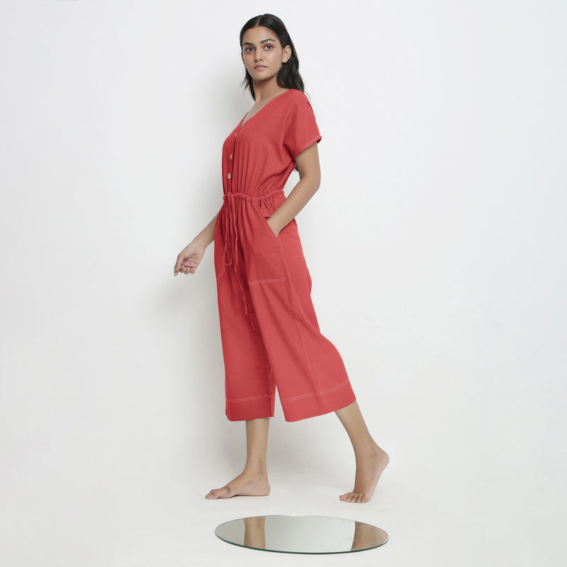 Left View of a Model wearing Brick Red Vegetable Dyed Button-Down Jumpsuit