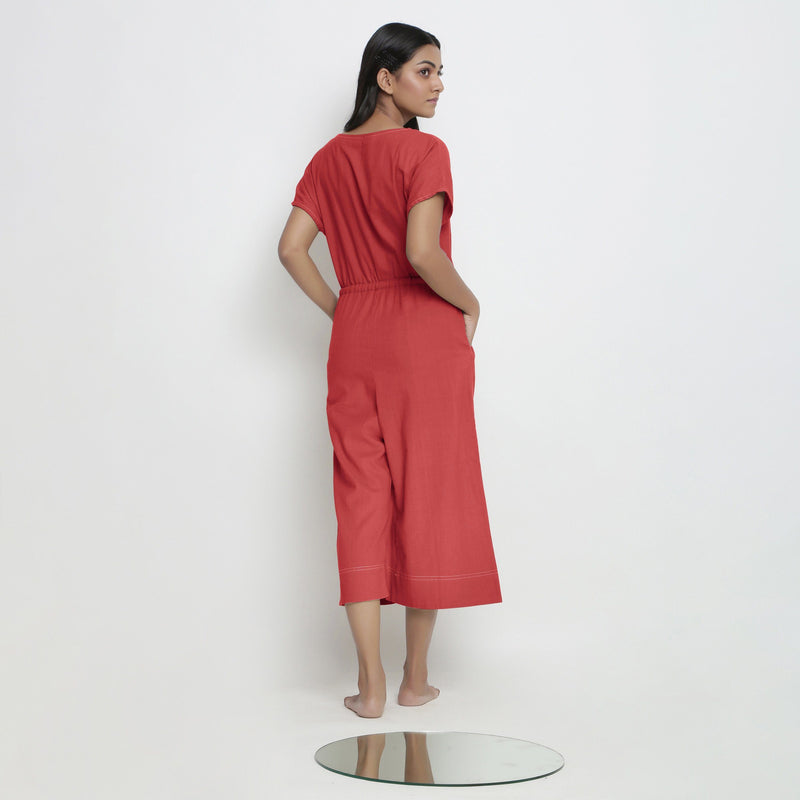 Back View of a Model wearing Brick Red Vegetable Dyed Button-Down Jumpsuit