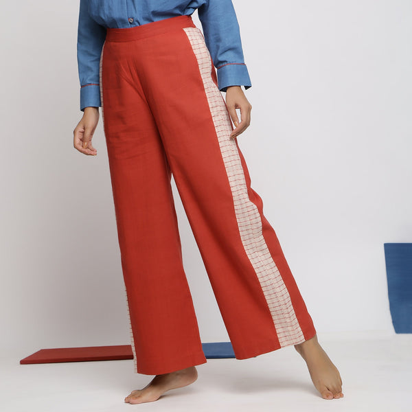 Left View of a Model wearing Brick Red Vegetable Dyed Handspun Cotton Wide Legged Pant