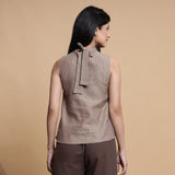 Back View of a Model wearing Brown and Beige Reversible Cotton Yoked Tie-Up Neck Top