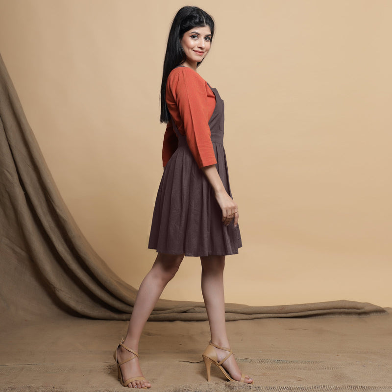 Right View of a Model wearing Brown Pleated Cotton Flax Knee Length Criss-Cross Back Dress
