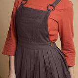 Front Detail of a Model wearing Brown Pleated Cotton Flax Knee Length Criss-Cross Back Dress