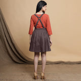 Back View of a Model wearing Brown Pleated Cotton Flax Knee Length Criss-Cross Back Dress