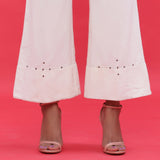 Close View of a Model wearing White Corduroy Hand Beaded Bootcut Pant