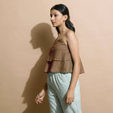 Left View of a Model wearing Brown Handspun Flared Camisole Top