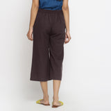 Back View of a Model wearing Brown Mid-Rise Cotton Flax Culottes