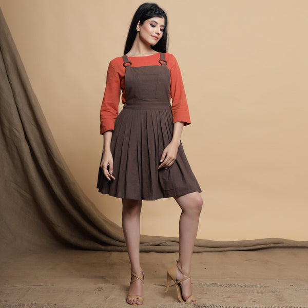 Front View of a Model wearing Brown Pleated Criss-Cross Back Dress