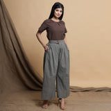 Front View of a Model wearing Brown Pleated Neck Top and Striped Pant Set
