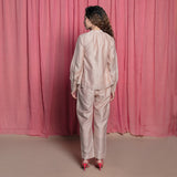 Back View of a Model wearing Champagne Cotton Chanderi Flared Tie Neck Top