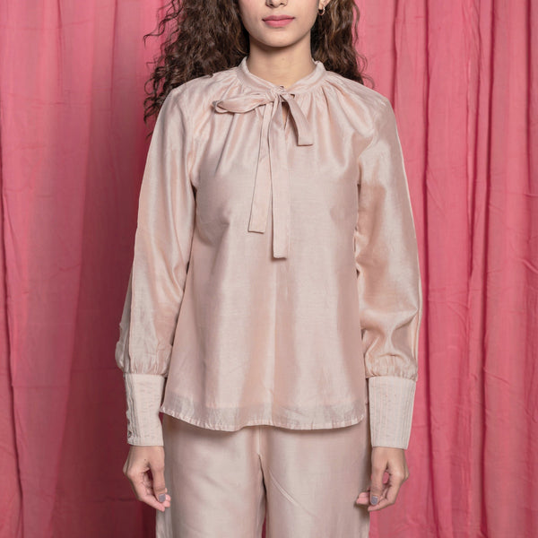 Front Detail of a Model wearing Champagne Cotton Chanderi Flared Tie Neck Top